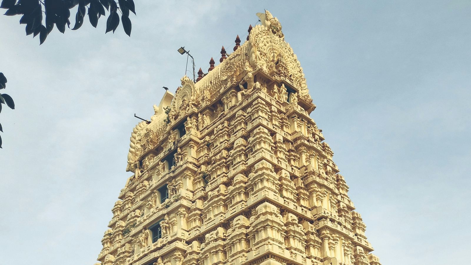 Towering gopuram of a South Indian temple with detailed carvings.