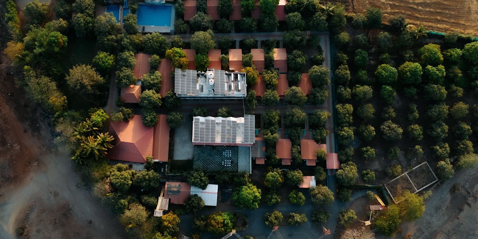 An overhead shot of Daksh Resort & Amusement Park, Sasan Gir, surrounded by greenery.