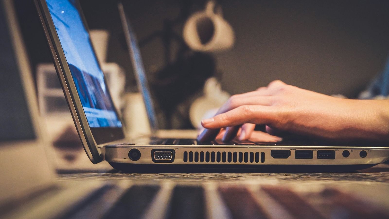 A person typing something on laptop