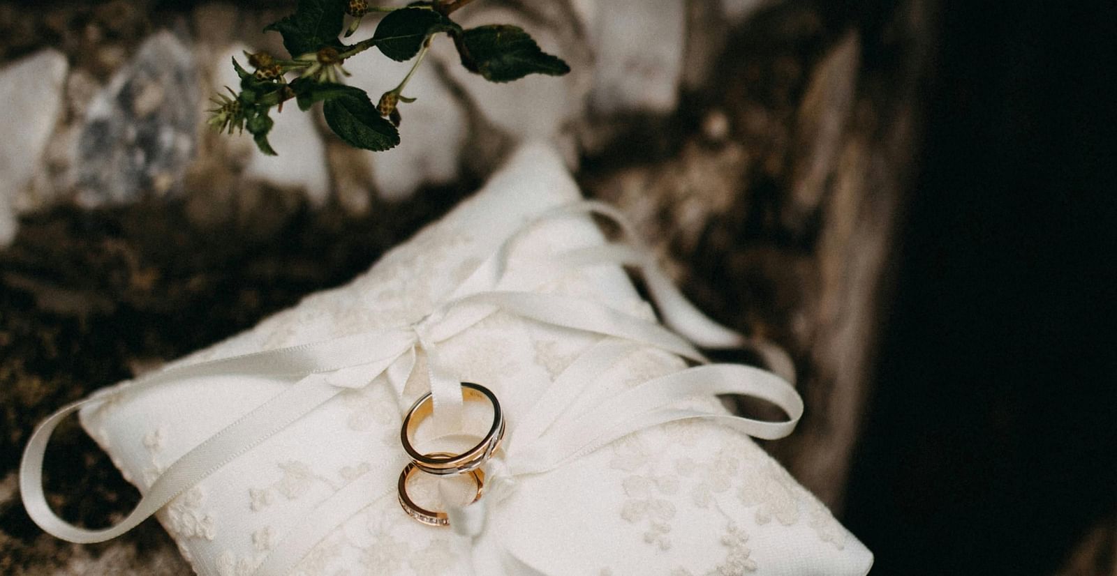 A wedding ring placed on a white pillow
