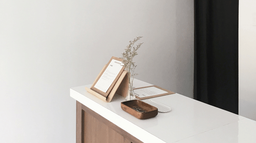 Image of a white table table and white walls. looks somewhat like a reception