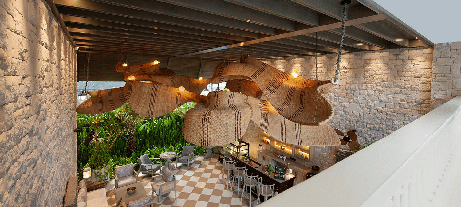 Full view of Suenos de Cafe taken from a higher level featuring an expansive dining area with ample of natural light falling over it.