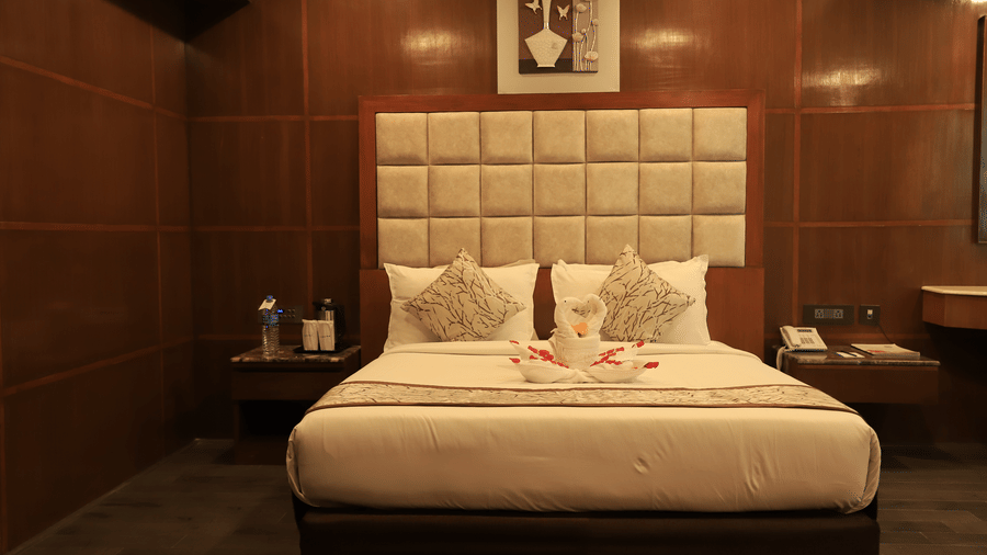 Contemporary hotel room with plush bedding and sophisticated interiors at Benzz Park, Chennai.