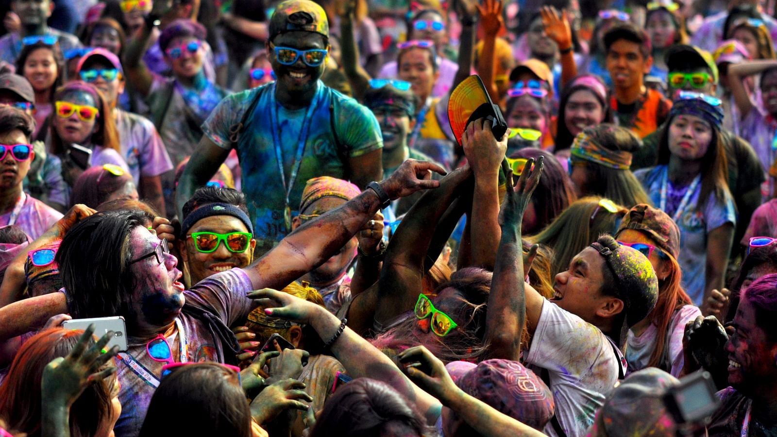 a group of people doused in colour