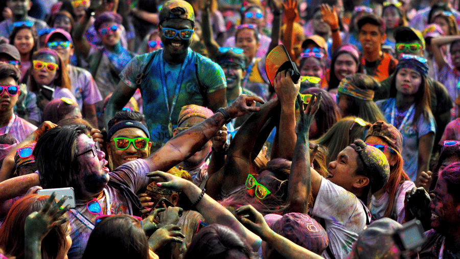 a group of people doused in colour