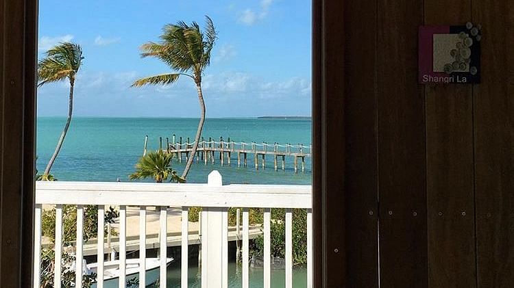 a sea view from a balcony with chairs at casa morada.