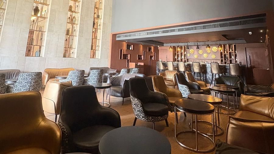 A bar with a geometric chandelier, emphasizing the lighting and the bar's unique design elements.