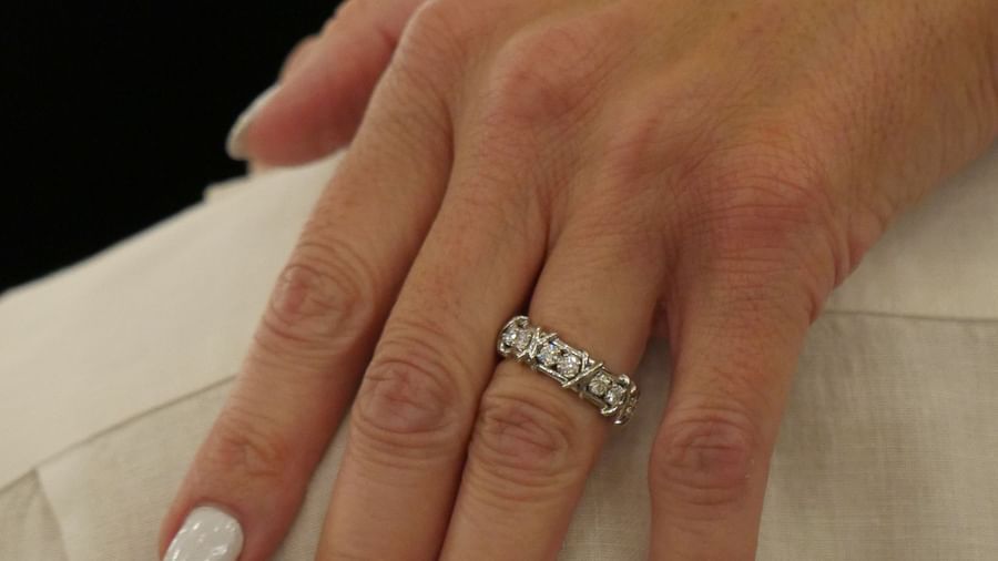 A close-up shot of a hand with a ring and white nail polish resting on a person's shoulder at Casa Morada.