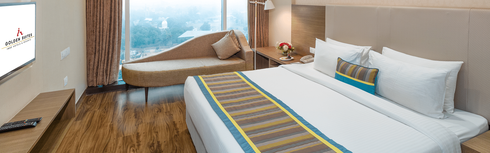Suite Bed room with comfy bed and window view at golden suite