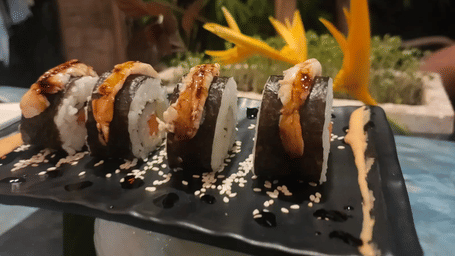 Delicious sushi rolls served at Cafe 4 at Matsya Island Retreat, Havelock, beautifully plated with sesame seeds in a tropical dining setting.