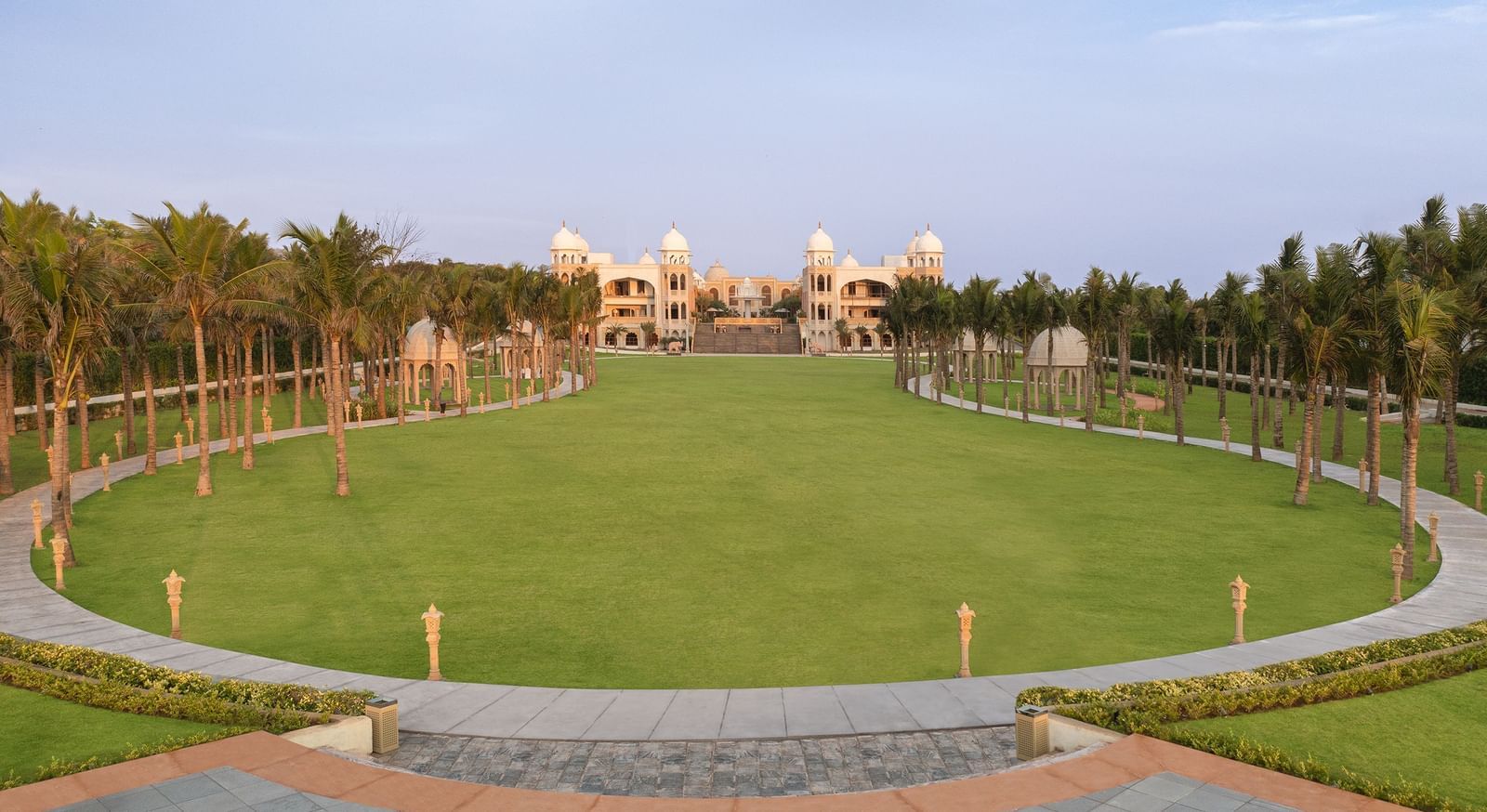 An oval-shaped outdoor lawn in Mahabalipuram surrounded by lights and lush greenery – Kaldan Samudra Palace, Mahabalipuram, one of the Best Marriage Lawns in ECR