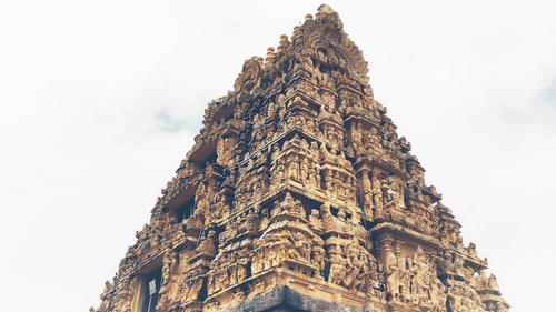 Facade image of a temple in Belur with intricate carvings on the roof