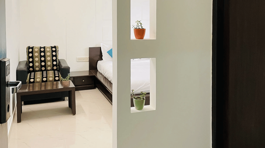 Well-lit room corridor with decorative shelves at Sanctum Suites Domlur Bangalore