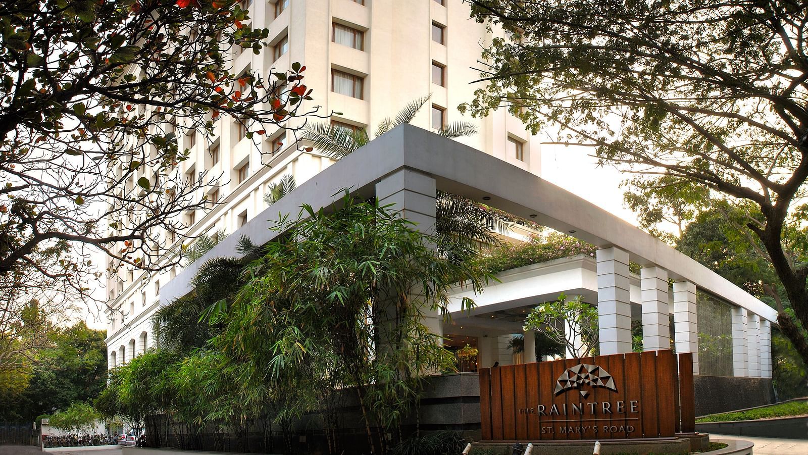 A facade view of The Raintree, St. Mary's Road, framed by trees.