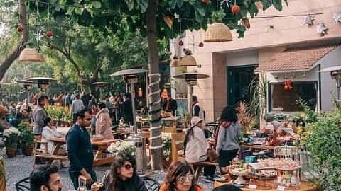 Guests seated outdoors during a food event or meal gathering at Karma Chalets.
