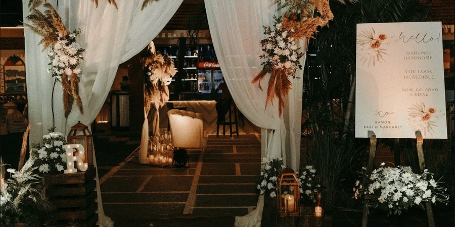 A decorated entrance for a night event with subtle lighting.