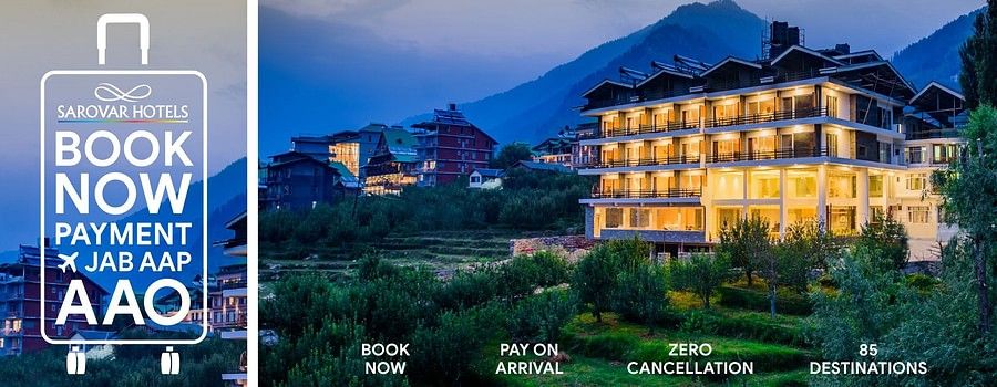 Scenic hillside Sarovar Hotels property at dusk with ‘Book Now, Pay on Arrival, Zero Cancellation’ banner promoting 85 destinations.