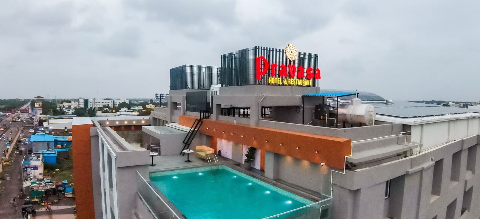 Rooftop swimming pool area of Pravasa Hotel with city views | Pravasa Hotel, Vijayapura