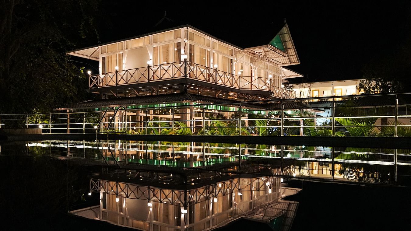 A picture featuring the exterior of the well lit building in the night