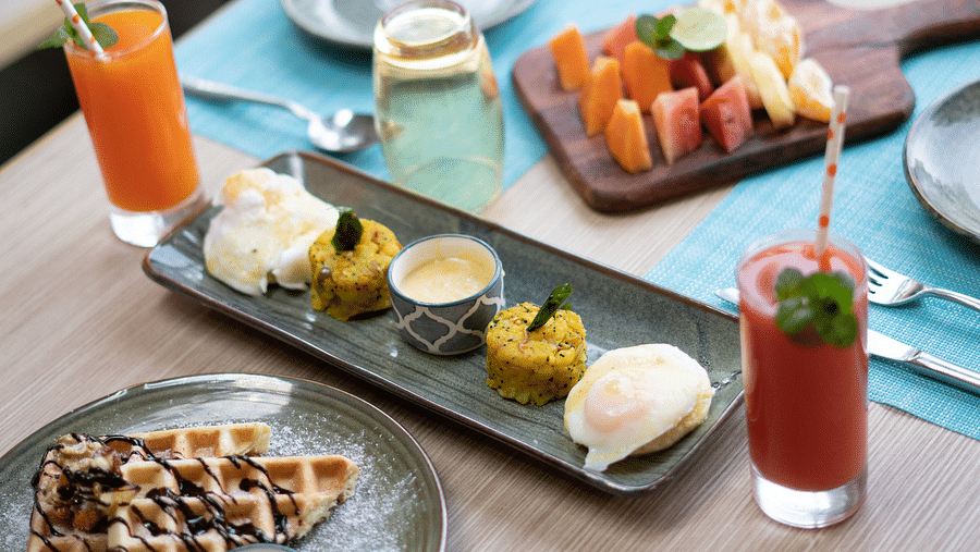 Waffles, fruit slices, and assorted desserts displayed on a plate at BluSalzz Escapade Resort, Lansdowne.