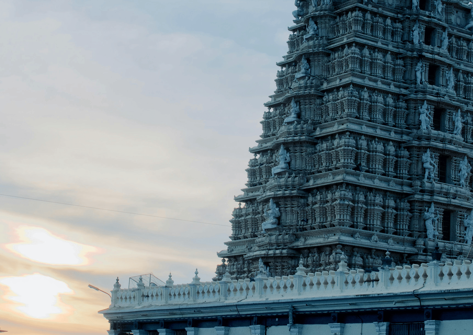 A temple gopuram standing tall against the sky in the temple city of Madurai.