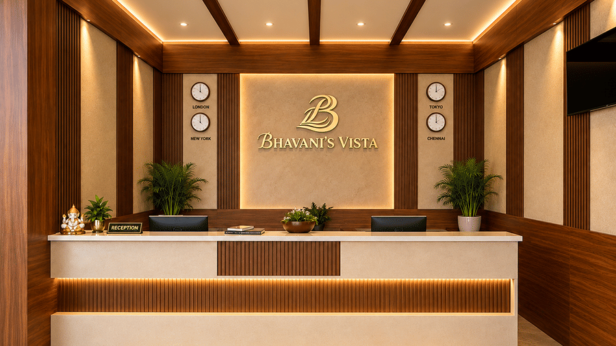 Modern front desk reception area with wooden paneling and warm ceiling lighting at Bhavani's Vista By Icon, Hosur.   