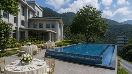 Outdoor event dining table set up with chairs near a swimming pool and hotel building exterior.