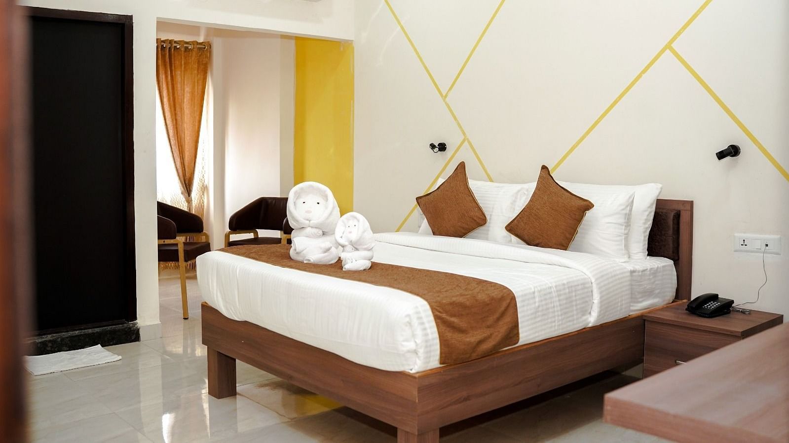 A well-lit room with a double bed at ANS M Square Hotel & Resort, Kalaburagi
