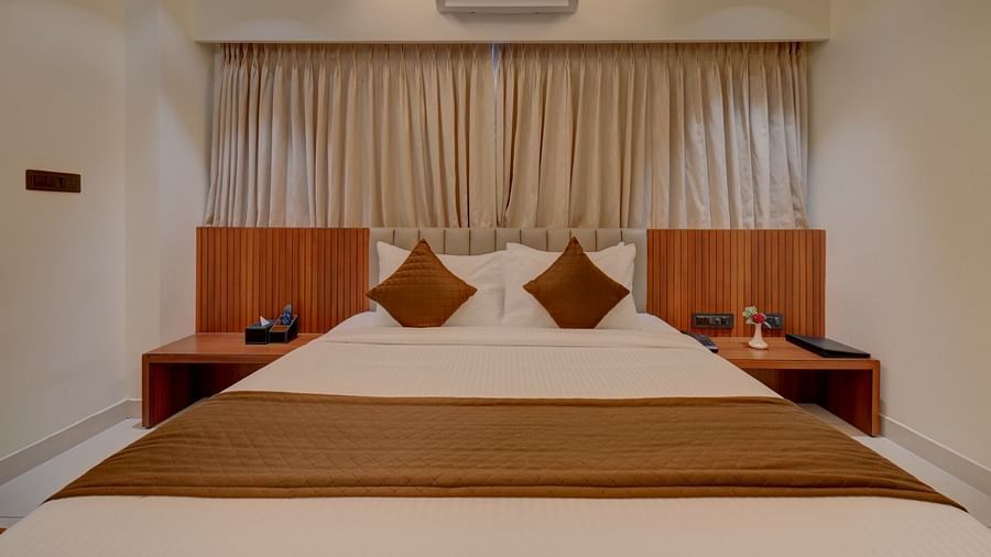 Image of a room with a bed with side tables on both sides at Hari Govindas, Siddappa Square.