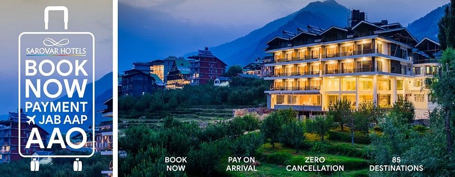 Scenic hillside Sarovar Hotels property at dusk with ‘Book Now, Pay on Arrival, Zero Cancellation’ banner promoting 85 destinations.