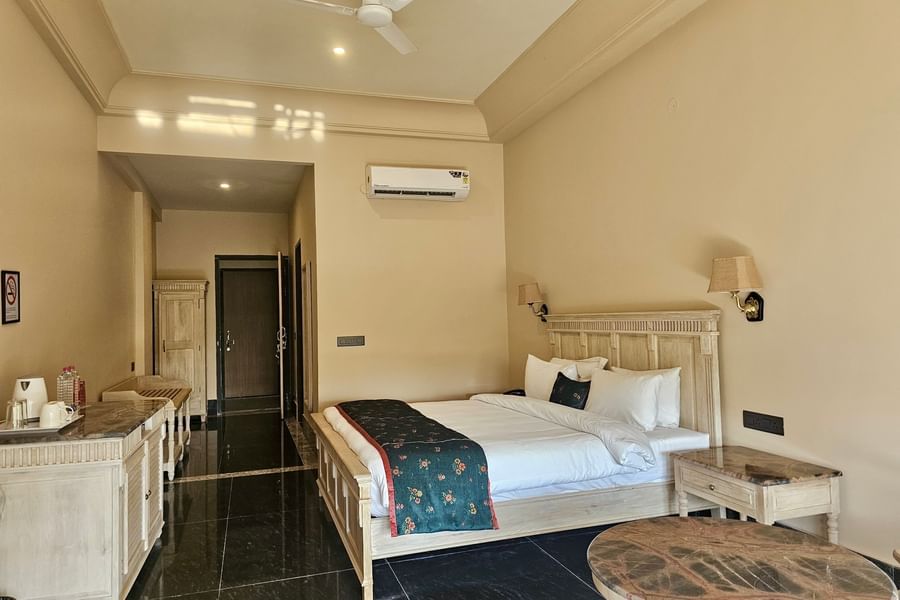 Luxury Rooms at Hotel Umaid Palace featuring a double size bed, bedside table, lamp, cabinet table, and AC.