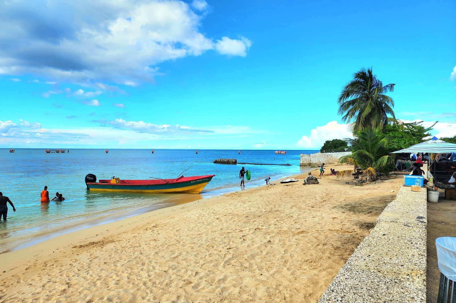 An image of the Dead End Beach with a boat reaching the shore - Hotel 39, Jamaica