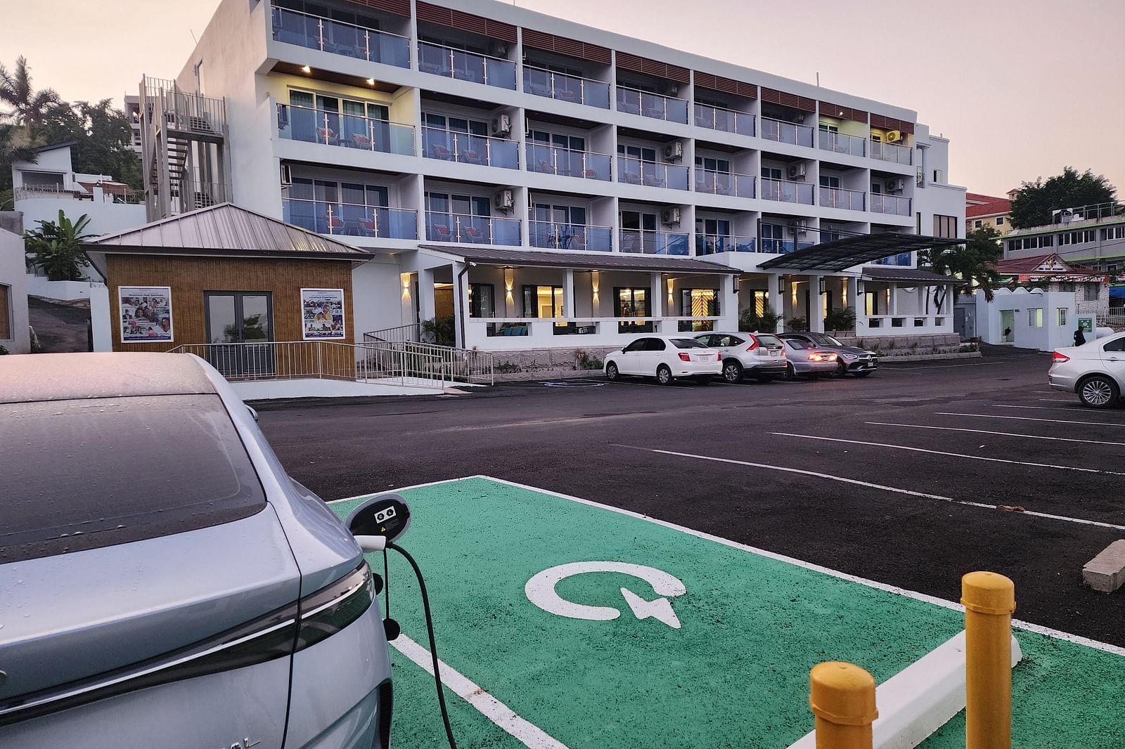 A hotel exterior with an electric car charging station in the parking lot - Hotel 39, Jamaica