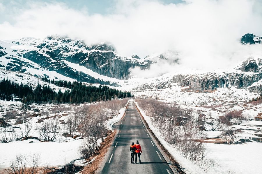 couple walking on a snow covered road 2