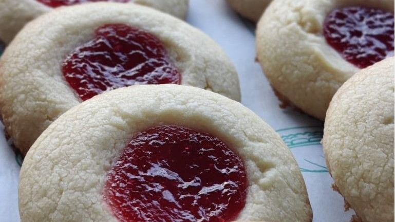 A delicious cookie with jam on it is platted in a row at Arcadia Heritage Resort, Darjeeling