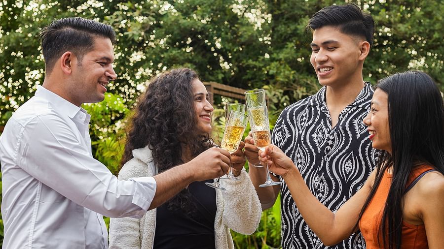 Friends relaxing with mocktails in the garden cafe at The Dukes Retreat surrounded by nature