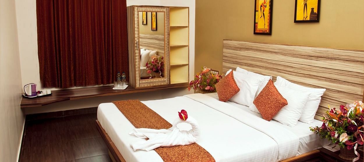 Flora Suite bedroom with a double bed and a wardrobe