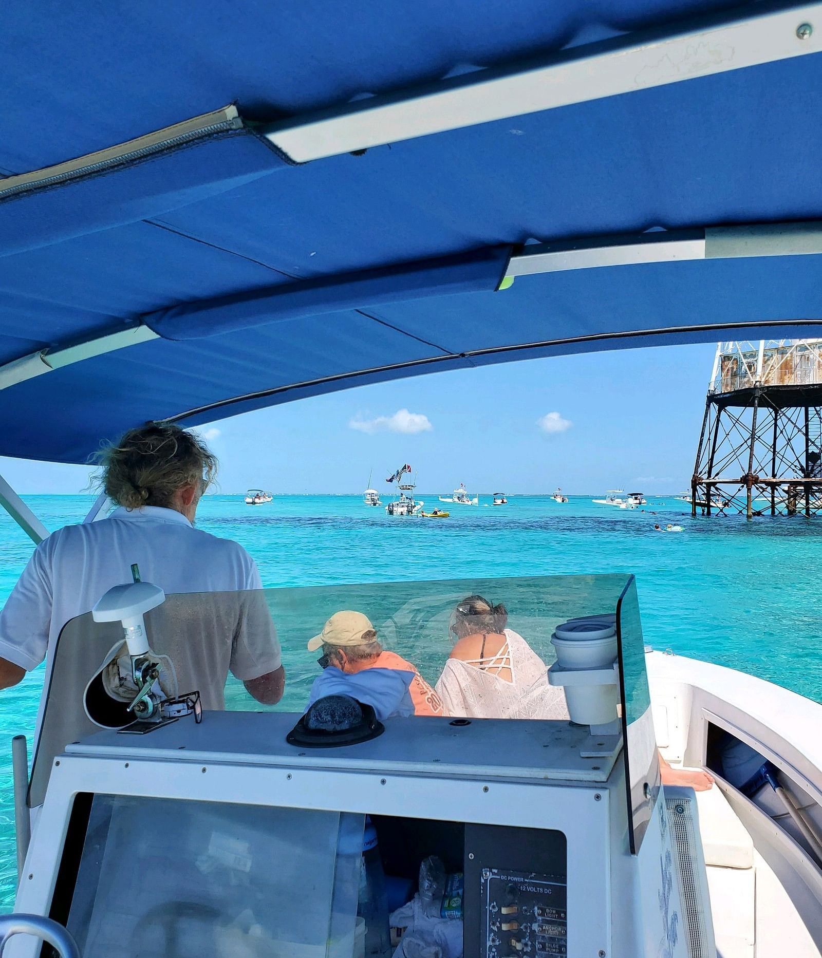 Guests onboard a boat ride with a canopy at Casa Morada, cruising through clear blue waters.