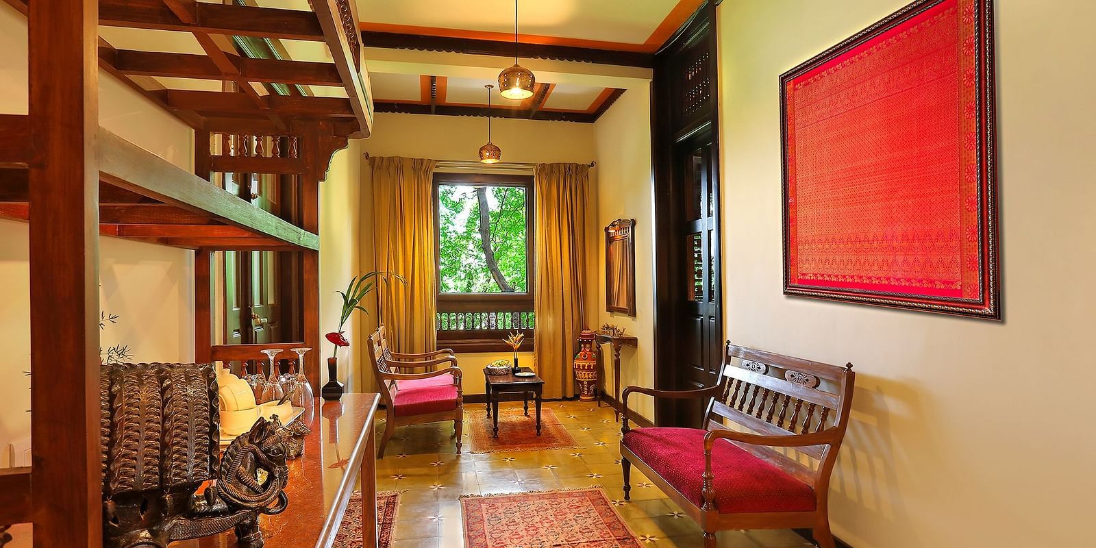 image of the living room featuring a small window at the end of the area at malnad palace suite at hoysala village resort in hassan