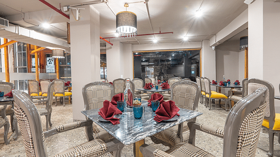 an image of a dining space with tables and chairs