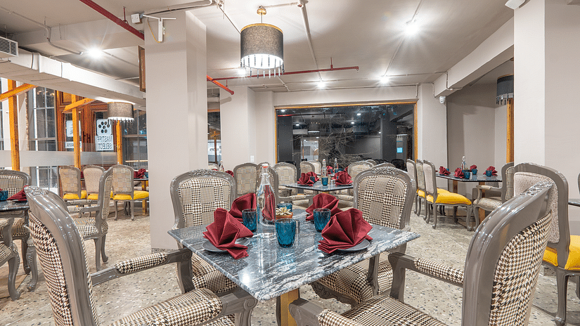an image of a dining space with tables and chairs