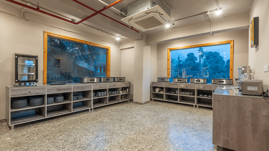 An image of a dining area where buffet is served at Mastiff Select Mandavya Dharamkot, McLeodganj
