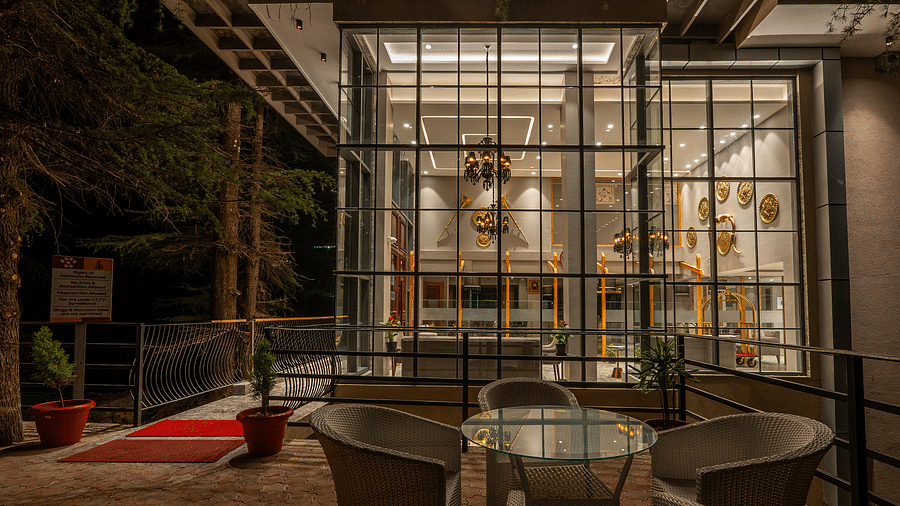 an image of outdoor seating space with chairs and a round table at Mastiff Select Mandavya Dharamkot, McLeodganj