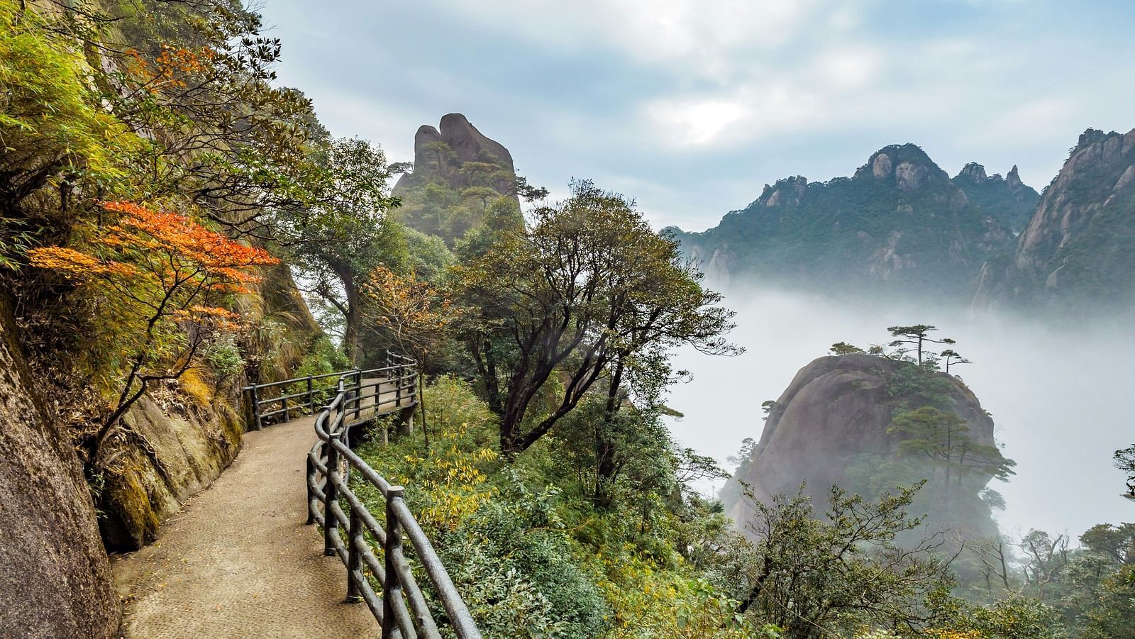 An image of a pathway by the side of mountains