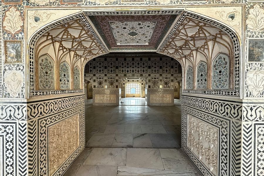 Intricately decorated hallway with arched doorways.