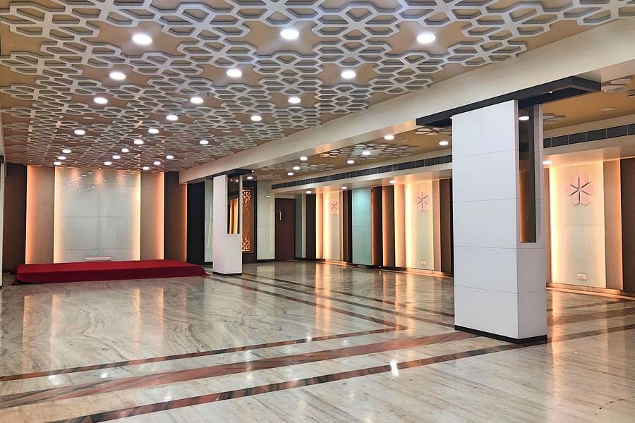 an empty Banquet Hall in Tirupati with many lights switched on - Raj Park Hotel, Tirupati