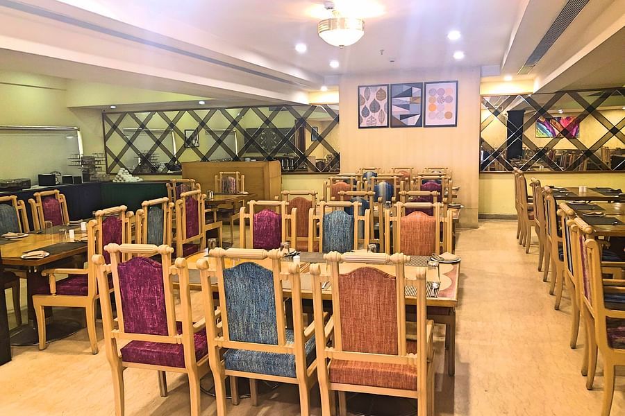 seating arrangments inside a restaurant with the lights switched on - Raj Park Hotel, Tirupati