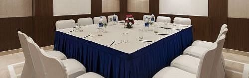 Board Room with a large square table and seating arranged on all four sides, ready for meetings and conferences at Inde Signature Tower, Gurgaon