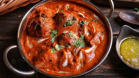 A mughlai delicacy served alongside some flatbread