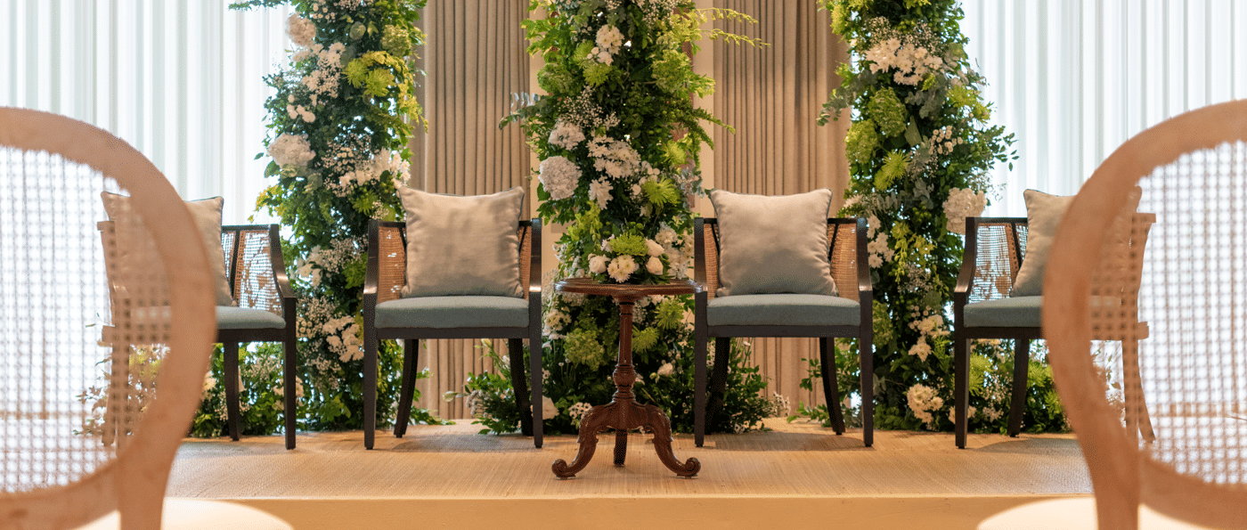Indoor seating area with two chairs and plants near large windows at The Raintree, St. Mary’s Road.